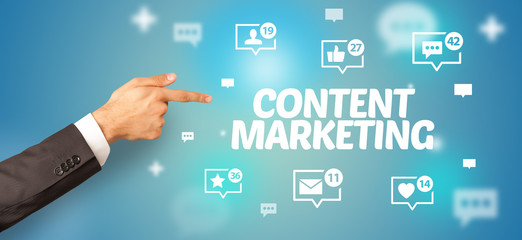 close-up of cropped hand pointing at content marketing inscription, social networking concept