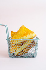 Poster - And appetizing pieces of pie in a metal basket on white background