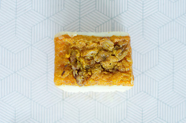 Poster - Low angle shot of a delicious and appetizing piece of cake on a white background