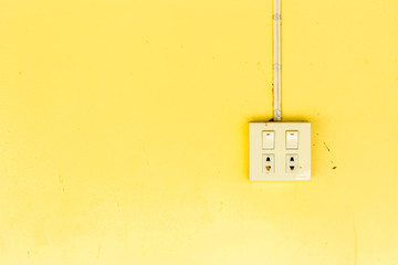 Old yellow wall sockets and switches