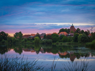 Wall Mural - pond Oberteich of the town Schönberg in the early morning with dramatic sky