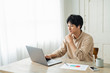 © One - One man working remotely and a cat.