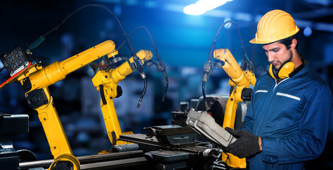 Smart industry robot arms for digital factory production technology showing automation manufacturing process of the Industry 4.0 or 4th industrial revolution and IOT software to control operation .