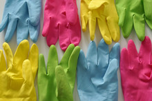 Closeup Shot Of Colorful Rubber Gloves On A White Surface