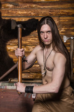 Viking With A Naked Torso And Long Hair Swung An Ax
