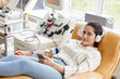 Portrait of female donor lying on the couch with mobile phone and looking at camera at the lab