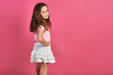 Poster - Little girl model posing on a pink background