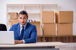 © Elnur - Young male employee in relocation concept
