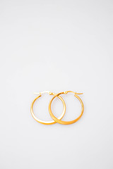 Wall Mural - Closeup shot of the elegant golden earrings isolated on white background