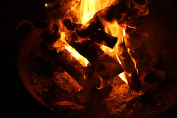 Poster - Closeup shot of a bonfire flashing in the dark