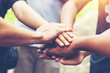 © tonjung - Solidarity unite people hands together community teamwork. Hands of spirit team working together outdoor. Unity strong handshake with people or agreement of feeling or happy diverse education action