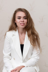 Wall Mural - Portrait of a girl in a white suit.