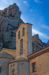 Poster - Low angle shot of an old building with bells on the tower in Montserrat