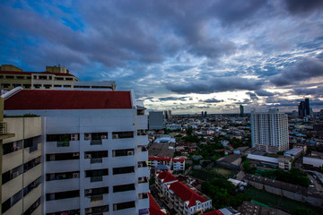 The high angle background of the city view with the secret light of the evening, blurring of night lights, showing the distribution of condominiums, dense homes in the capital community