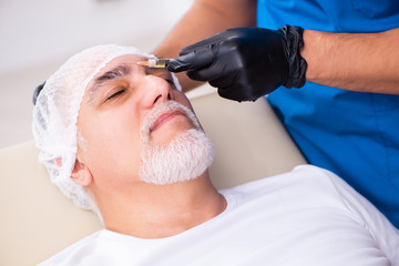 Wall Mural - Old man visiting male doctor for plastic surgery