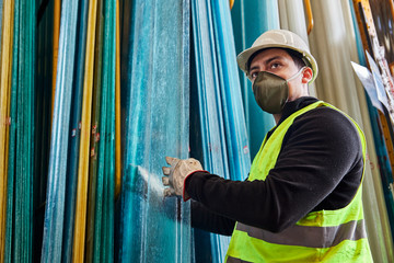 young man wearing a mask in the middle of his job as a construction tool salesman