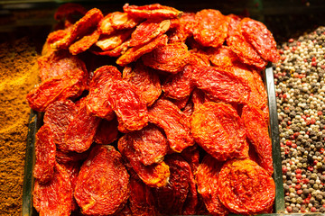 Sticker - Closeup shot of dried fruits surrounded by spices in the market