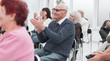 © ASDF - a group of senior citizens applaud in the conference room