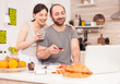 © DC Studio - Couple talking online with family on a video call during breakfast. Videoconference in the morning, using online web internet technology, talking and communicating with relatives