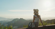 © leungchopan - Woman enjoy the view at sunset time on mountain