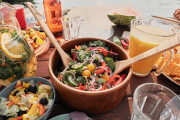 Wall Mural - Close-up of bowl with fresh vegetable salad on the table for the dinner on fresh air