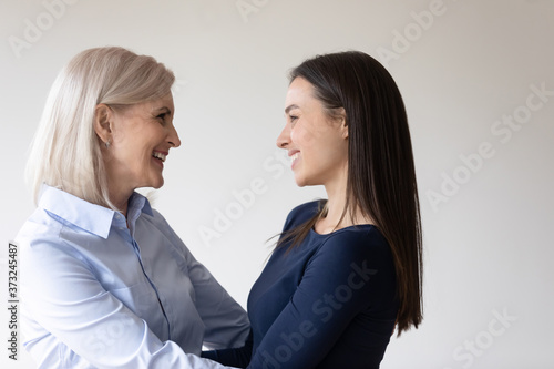 How much I missed you. Happy smiling mature mother holding in arms grown-up adult daughter looking at her face with love and tender, glad to see her again after long time apart. Long-awaited meeting