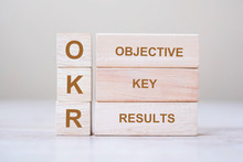 OKR Text (Objectives, Key And Results) Wooden Cube Blocks On Table Background. Business Target And Focus Concepts
