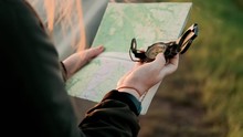 Close Up Hands Of Hiker Tourist Traveler Man With Compass Looking For Map Route, Traveling On Mountain, Active Lifestyle Hiking Enjoying Vacation Travel Tourism Adventure Landscape Nature. Travelling 