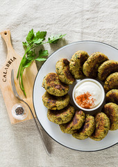 Wall Mural - delicious vegan eggplant cutlets with yogurt and hot pepper sauce, cuisine of the Calabria region in Italy on a linen tablecloth on the table