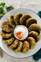 Wall Mural - delicious vegan eggplant cutlets with yogurt and hot pepper sauce, cuisine of the Calabria region in Italy on a linen tablecloth on the table