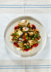 Wall Mural - grilled eggplant wrap with red bell pepper hummus and spicy yogurt on the table. delicious vegan recipe