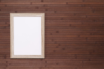 Empty wooden frame mockup on mahogany boards background. Mahogany wooden wall paneling background. Background concept for website.