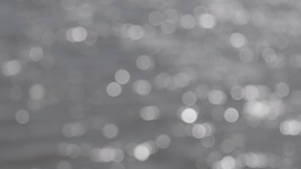 Wall Mural - bokeh sun glare reflected in water surface. abstract ripples, sun glares, circles on waves water. ro