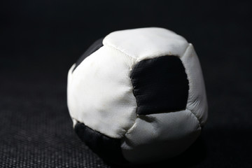 Canvas Print - Closeup of a soft soccer ball toy under the lights with a dark blurry background