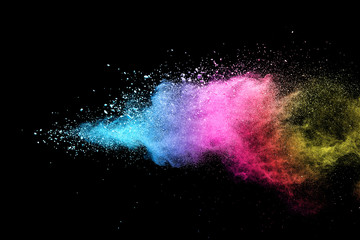 Wall Mural - Explosion of colored powder isolated on black background. 