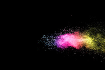 Wall Mural - explosion of colored powder isolated on black background.