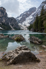 Wall Mural - View over the Latemar mountain group in the italian Alps taken from the level of the frozen Braies lake at the end of the winter - Prags, Trentino-South Tyrol, Italy