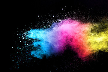 Wall Mural - explosion of colored powder isolated on black background.
