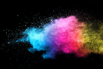 Wall Mural - explosion of colored powder isolated on black background.