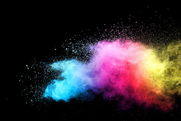 Wall Mural - explosion of colored powder isolated on black background.