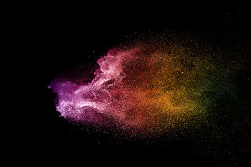 Wall Mural - Explosion of colored powder isolated on black background. 