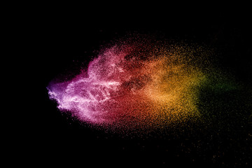 Wall Mural - explosion of colored powder isolated on black background.
