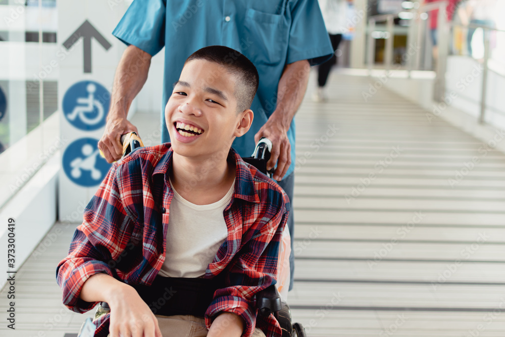 Asian special child on wheelchair and his father smiling happy face on ...