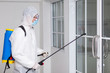 © Pornsak - Male medical staff wearing PPE suits to protect against COVID-19 using nebulizers. And use chemicals disinfectant glass door handle.