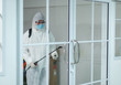 © Pornsak - Male medical staff wearing PPE suits to protect against COVID-19 using nebulizers. And use chemicals disinfectant glass door handle.