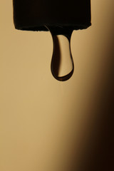 Sticker - Vertical shot of a water drop falling on a yellow background