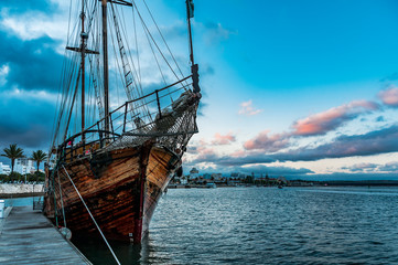 Recreational pirate ship in Portimao. Beautiful old ship that docks in the port of Portimao. Organize excursions for tourists. Made of wood, and with two masts, it transports us to the times of ancien