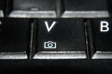 Computer keyboard detail on button with icon of camera