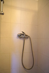 Canvas Print - Vertical shot of water tap and shower in a bathroom