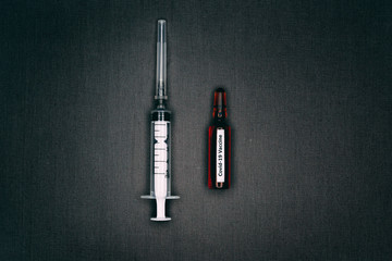 ampule of vaccine with syringe and needle 